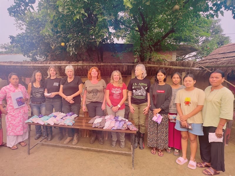 Social impact Nepal Women cheering on motorcycles in the mountains